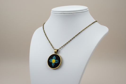 Zia Symbol Embroidered Bronze Pendant (Turquoise & Yellow)