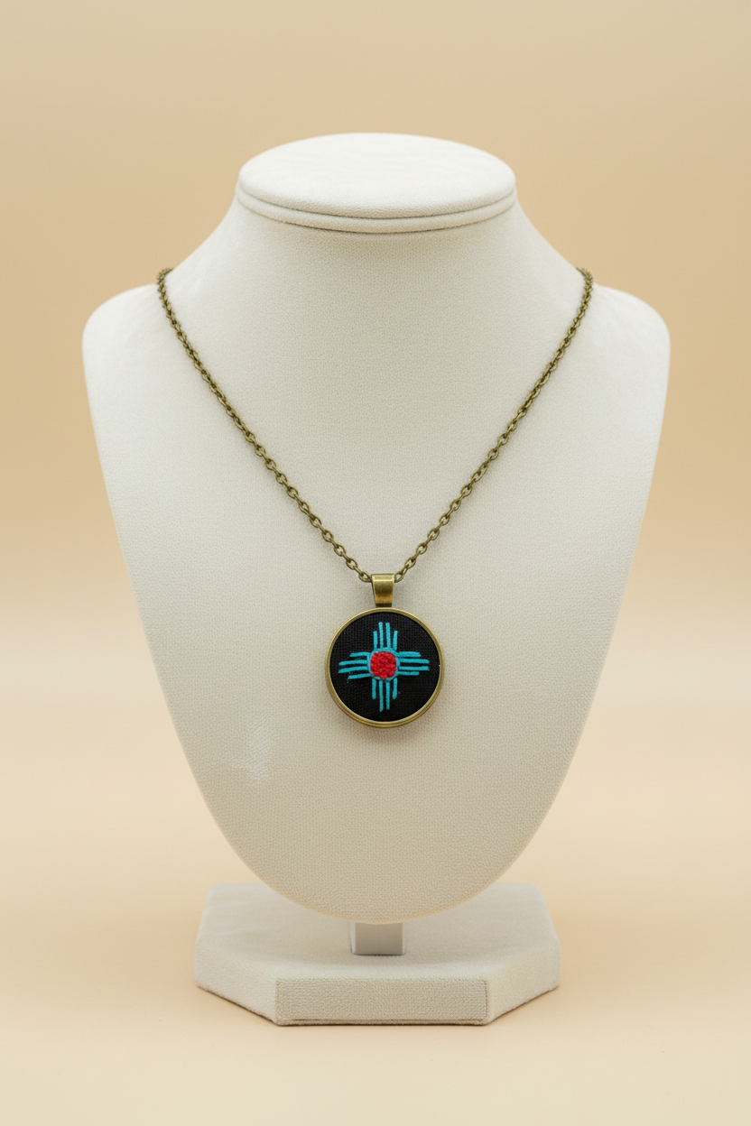 Zia Symbol Embroidered Bronze Pendant (Turquoise & Red)
