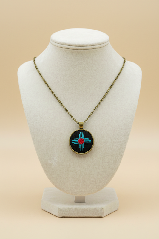 Zia Symbol Embroidered Bronze Pendant (Turquoise & Red)